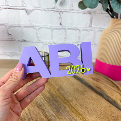 3D Schriftzug Abi 2026 in Lila mit neongelber Jahreszahl als Abi Abschluss Geschenk – moderne Deko aus PLA zum Abitur