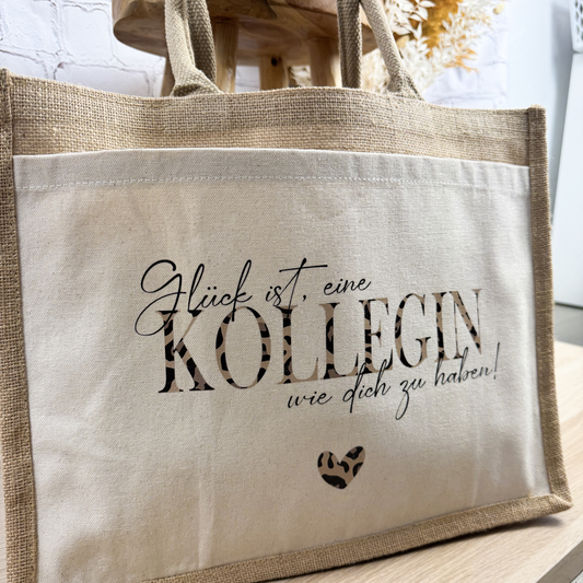 Jutetasche mit Spruch „Glück ist, eine Kollegin wie dich zu haben“ und Herzmotiv – perfektes Geschenk für Kolleginnen.