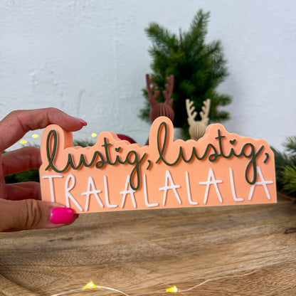 Nikolaus-Spruch „lustig, lustig, tralalala" in einer Hand gehalten als Größenvergleich