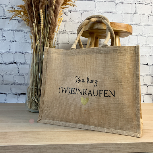 Nachhaltige Jutetasche mit humorvollem Spruch „Bin kurz (W)EINKAUFEN“, ideal als Geschenk für Frauen.